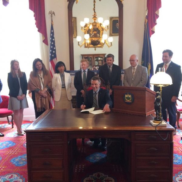 Governor Phil signs captive legislation along with industry leaders.