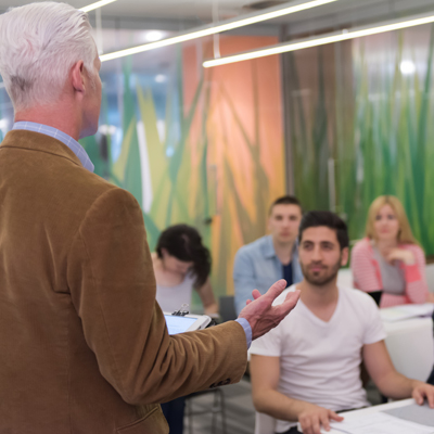 Professor speaking to a class of students.