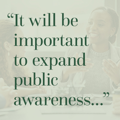 Quote overlaid on a photo of a two professionally-dressed women speaking: "It will be important to expand public awareness..."